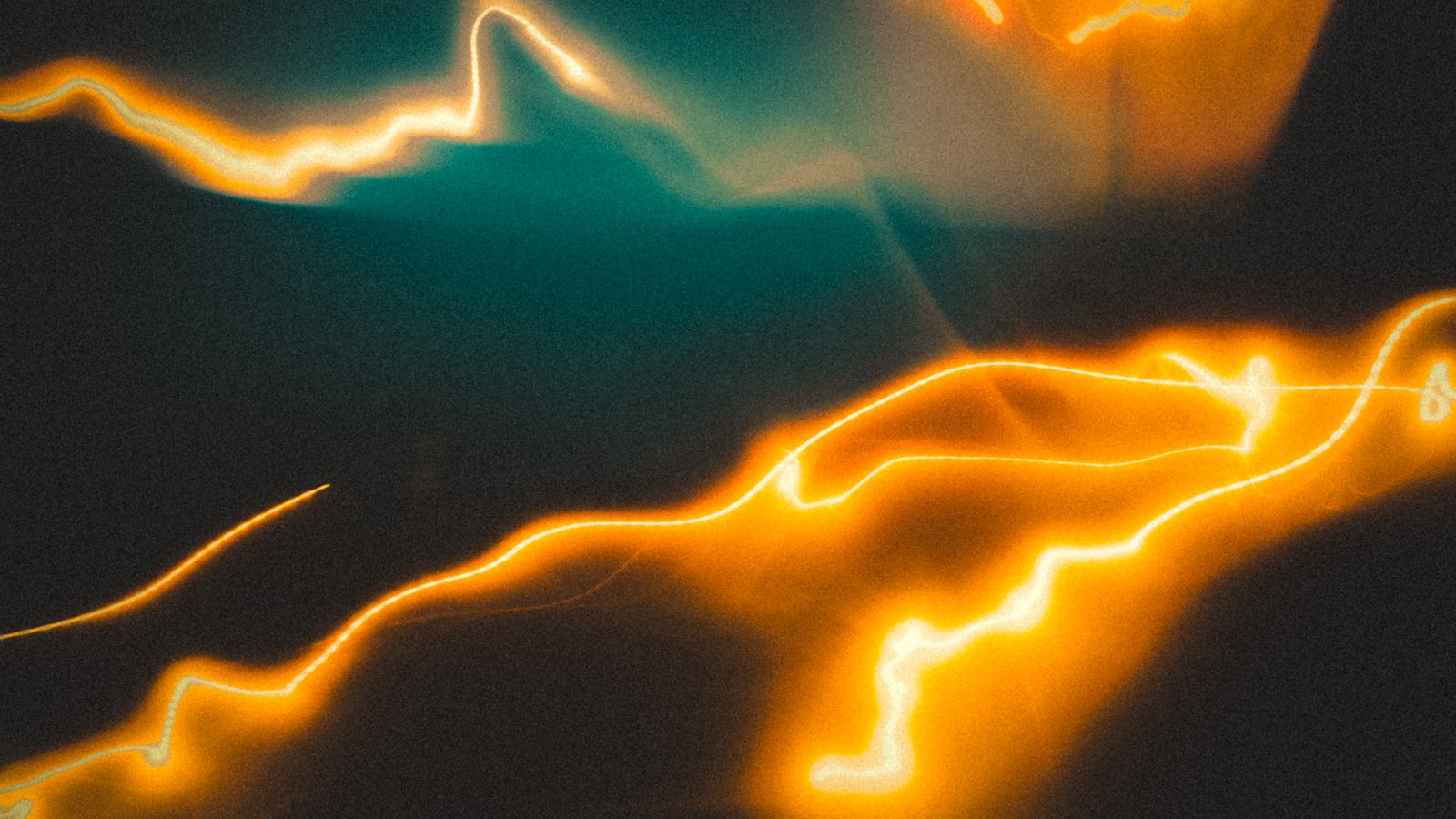 Glowing orange lines move across a dark backdrop.